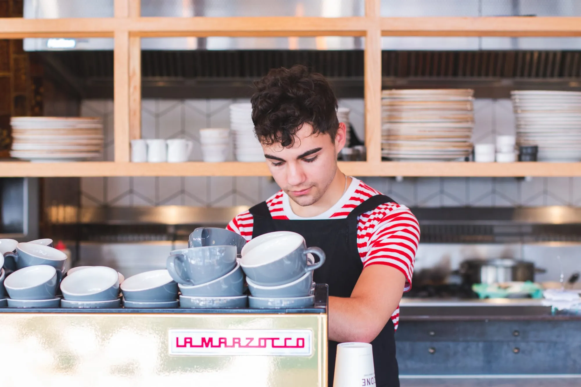 A barista at the espresso machine