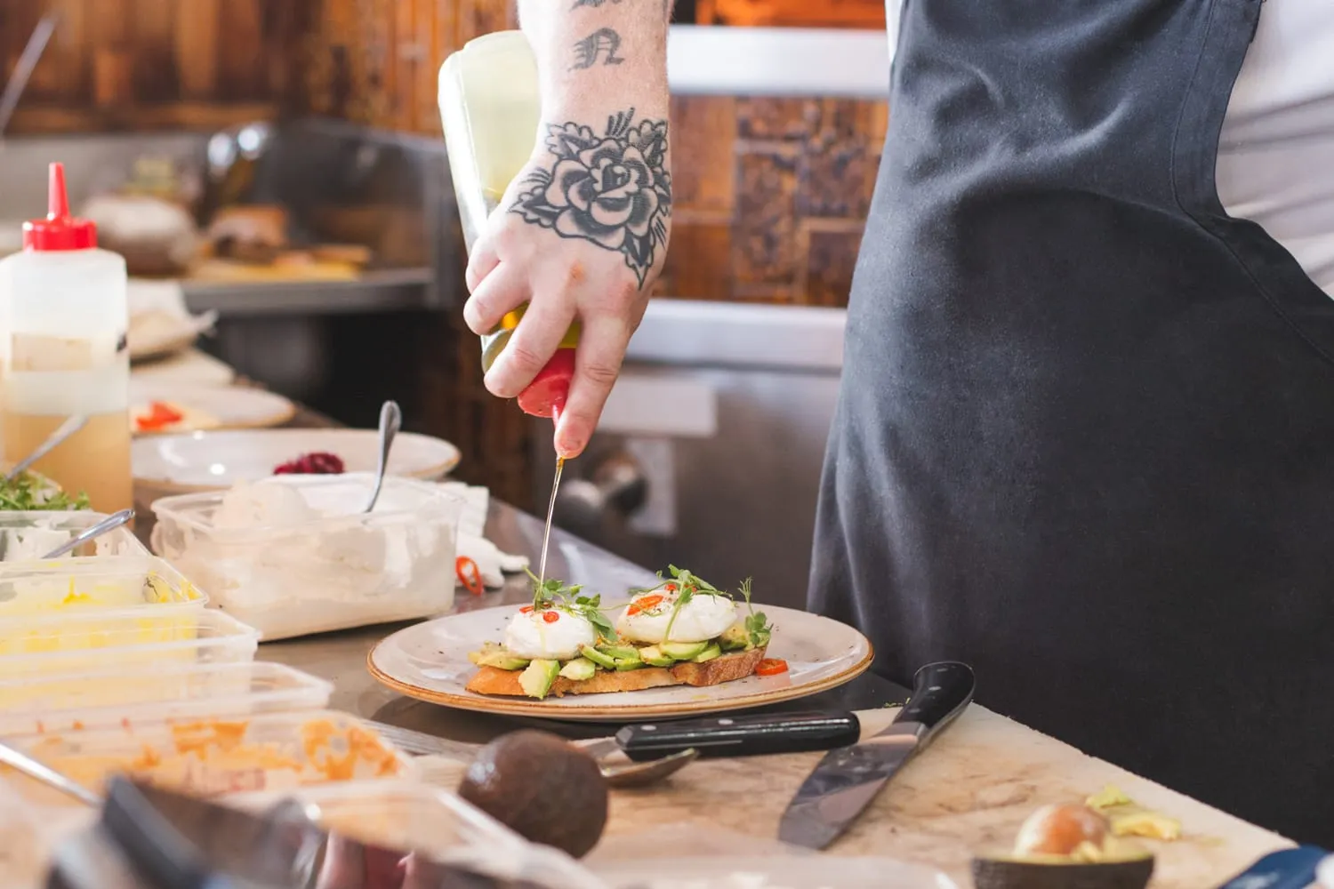 A chef finishing a plate in the kitchen
